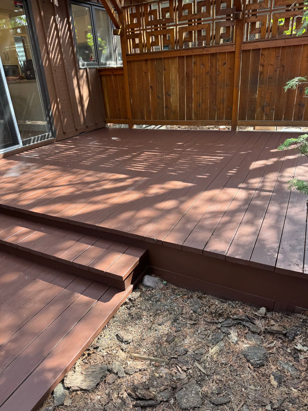 Premium deck stain over fully-sanded boards. Edge-to-edge seal — built to hold through ten Alberta winters.